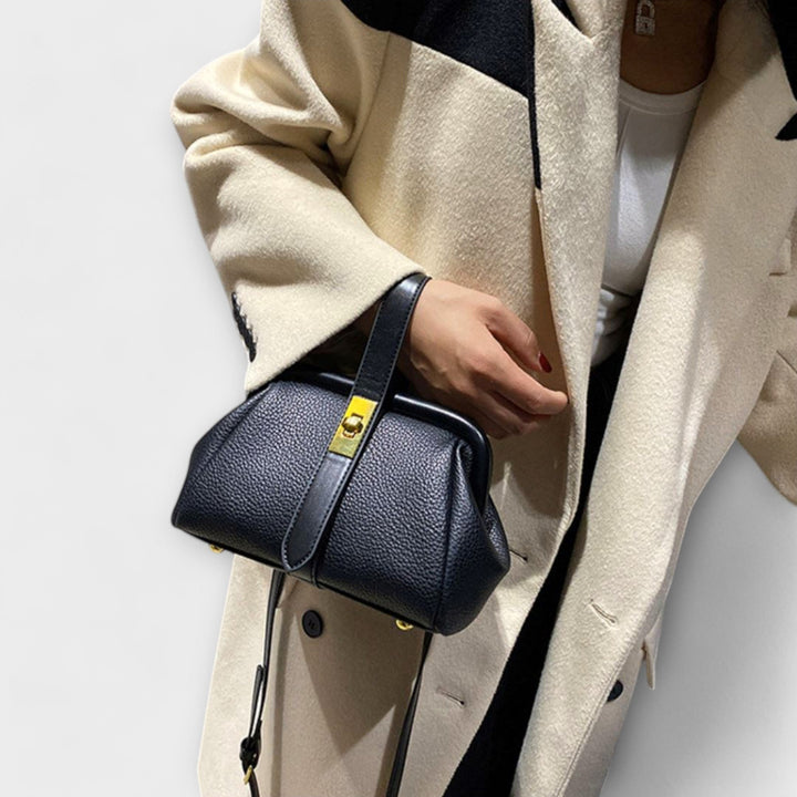 Sophisticated black mini handbag, a versatile shoulder bag for women's fashion.