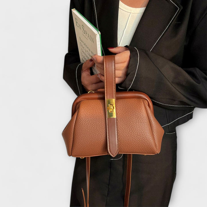 Women's top handle mini handbag, a chic and elegant accessory for any outfit.