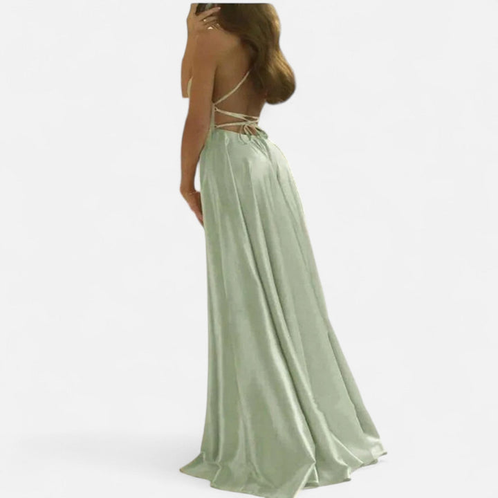 Woman wearing a chic black maxi dress with a sophisticated slit, ideal for cocktail parties