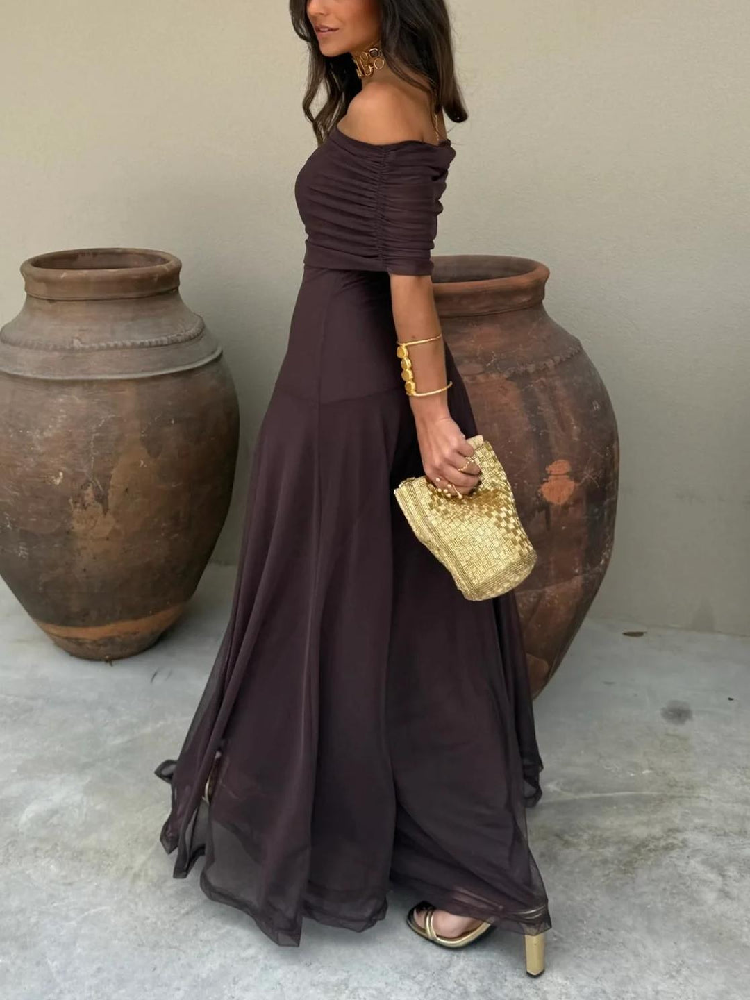 Women's elegant off-shoulder evening dress in a maxi length, suitable for special occasions.