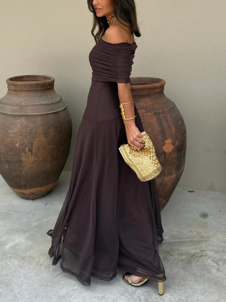 Women's elegant off-shoulder evening dress in a maxi length, suitable for special occasions.