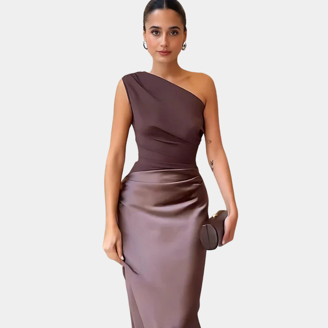 Luxurious ruby red one-shoulder satin maxi dress with tasteful ruching for a soft look.