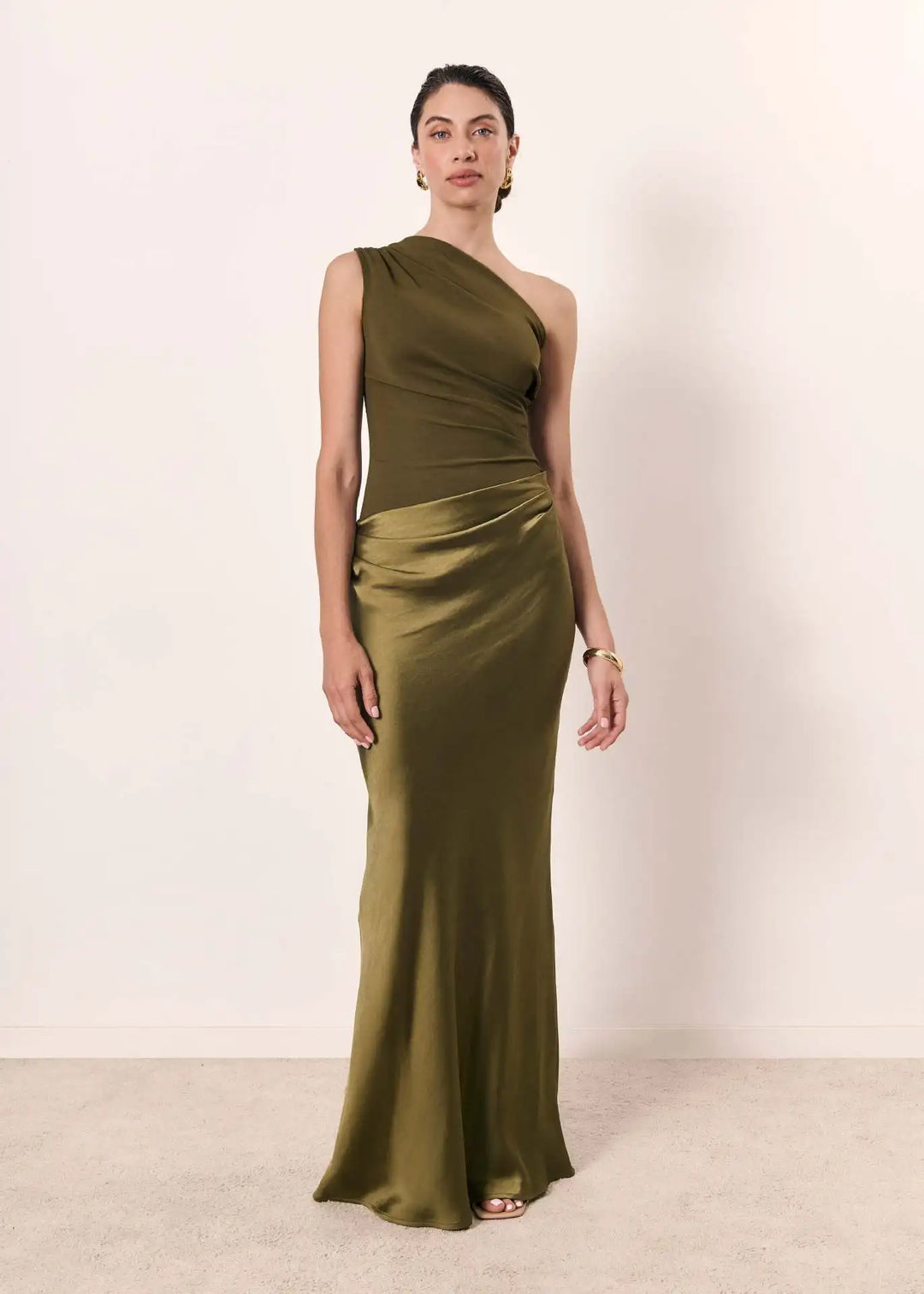 Close-up of the delicate ruching detail on a purple one-shoulder satin maxi party dress.
