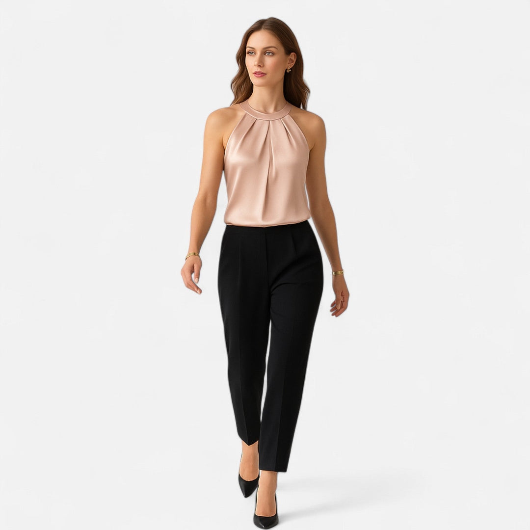 Beige sleeveless satin tank top with sophisticated pleats and drape, ideal for women's fashion.