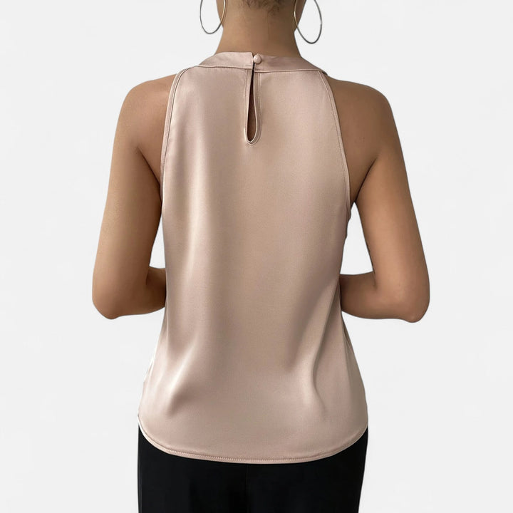 Full view of a women's elegant pleated draped beige satin tank top, a chic addition to any wardrobe.