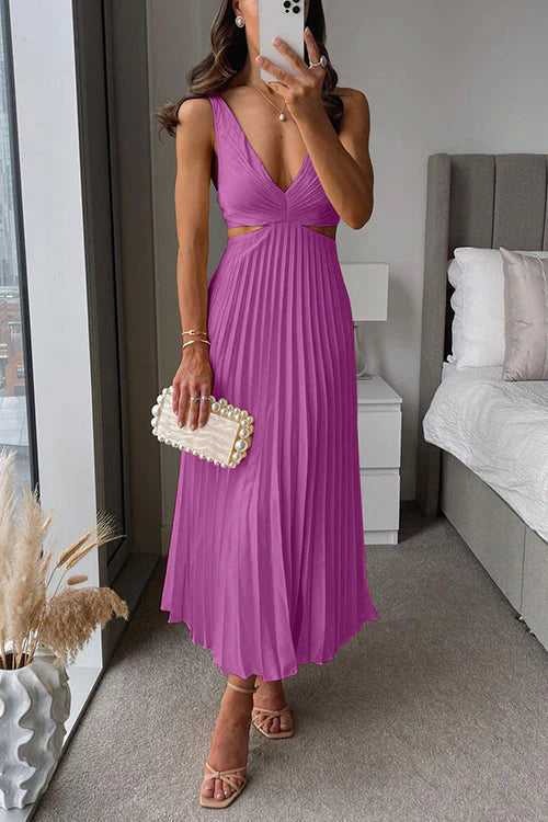 Detail of the V-neck and cut-out waist on an elegant pleated maxi dress, flowy summer gown style