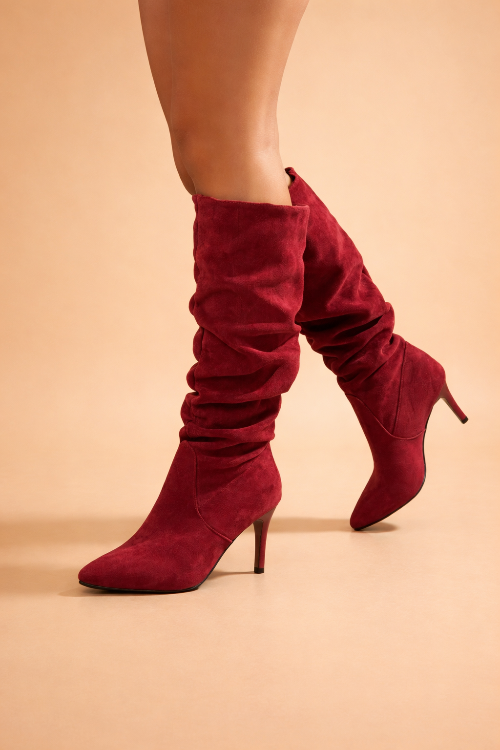 Classic black women's slouch knee-high heeled boots, featuring a pointed toe and elegant stiletto heel. Versatile winter style.