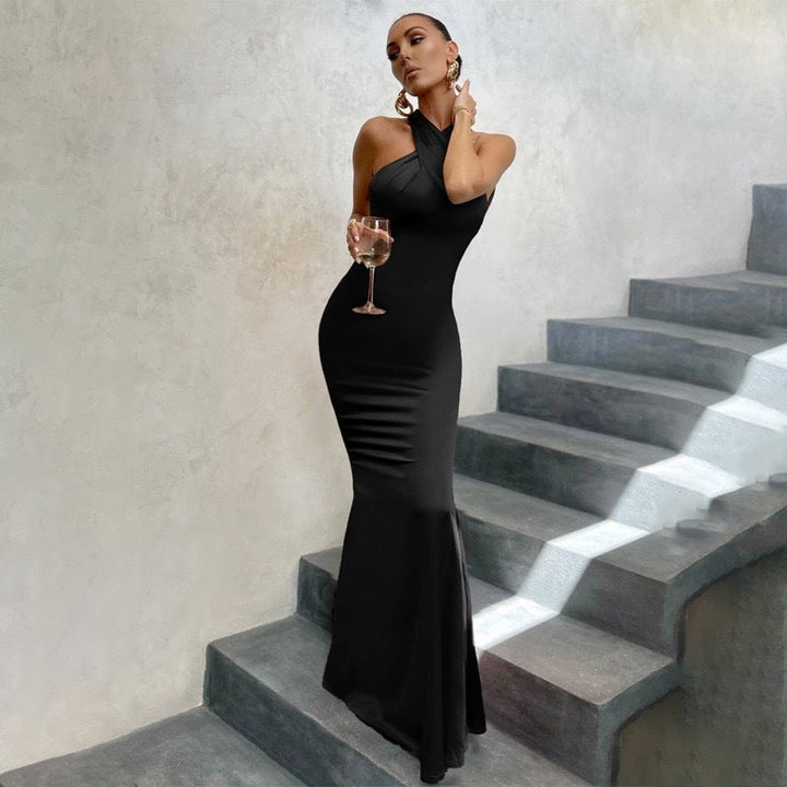Elegant sleeveless black fishtail maxi dress with open back, perfect for an evening party.