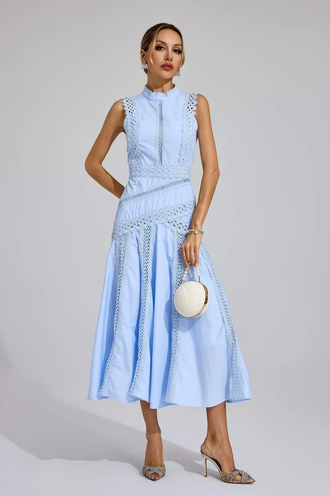 A women's elegant sleeveless yellow lace cocktail dress styled for a daytime casual party.