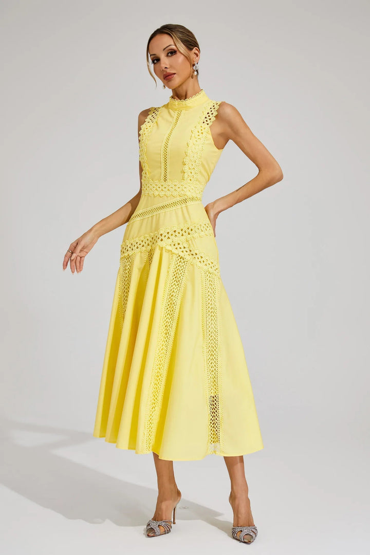 Side profile of a woman in an elegant sleeveless yellow lace midi dress, suitable for parties.