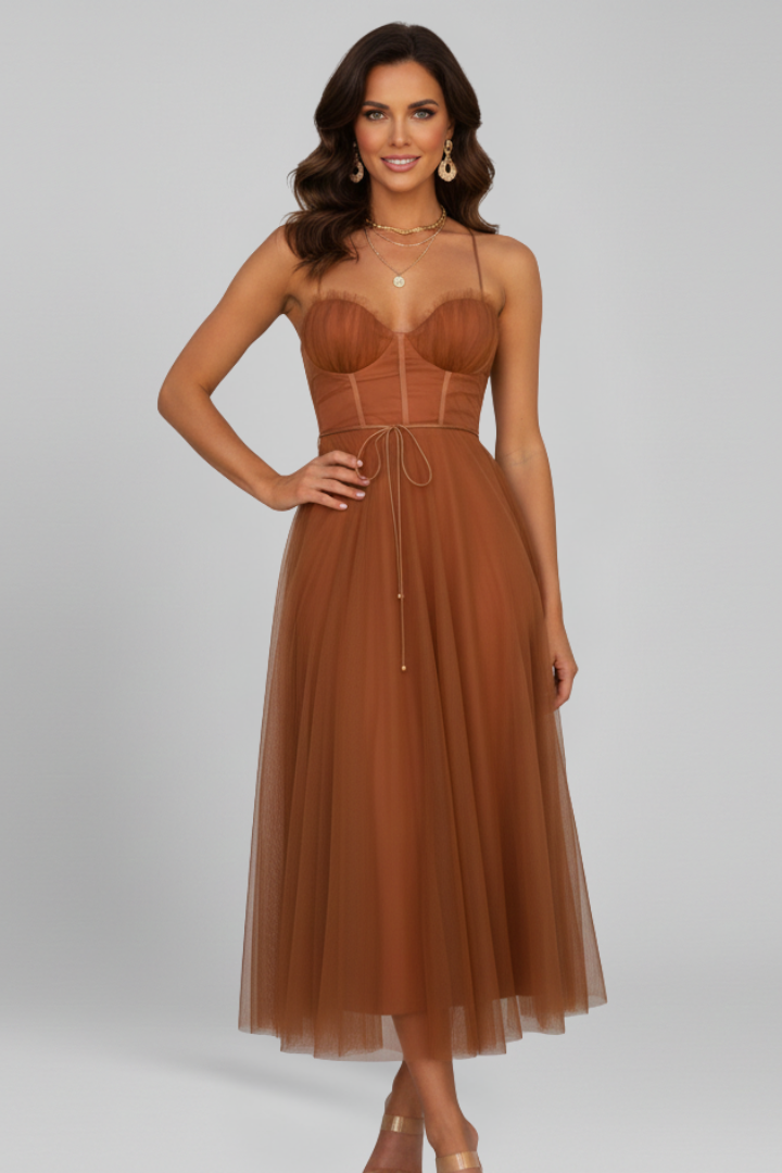Model wearing an elegant strapless tulle maxi dress, showcasing its graceful drape and fit.