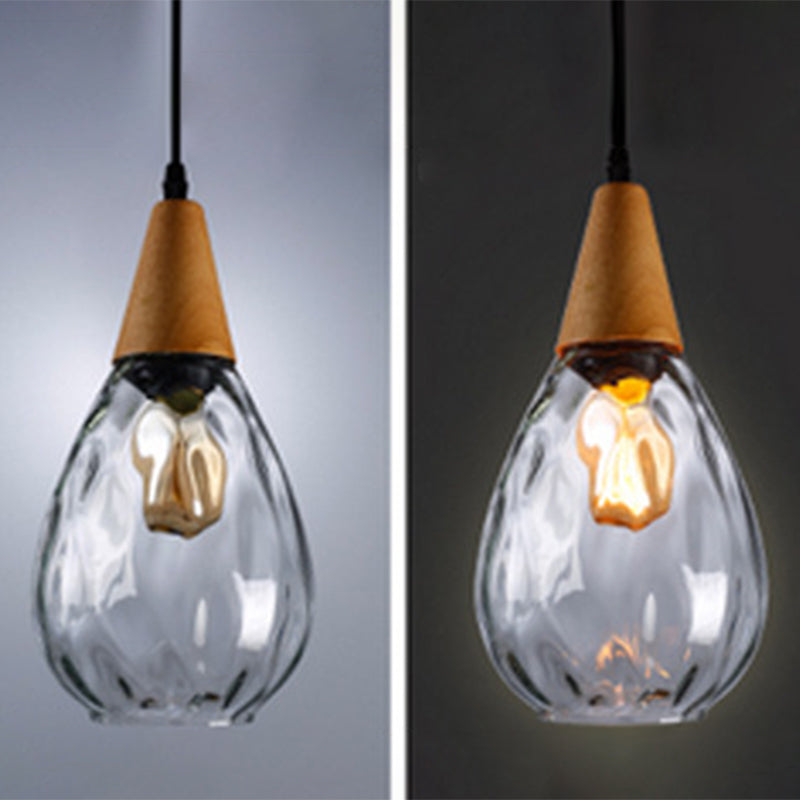 Minimalist teardrop glass pendant light, modern ceiling fixture design.