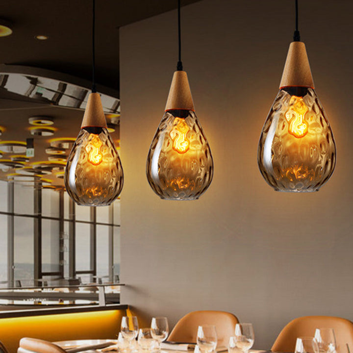 Clear glass teardrop pendant, creates soft ambient modern lighting.