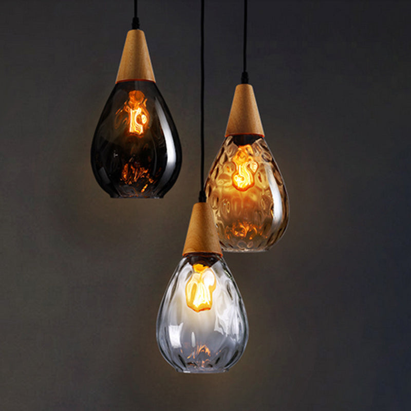 Hanging teardrop glass light, elegant ceiling lamp for modern spaces.