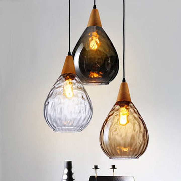 Modern teardrop glass pendant light for stylish kitchen island lighting.