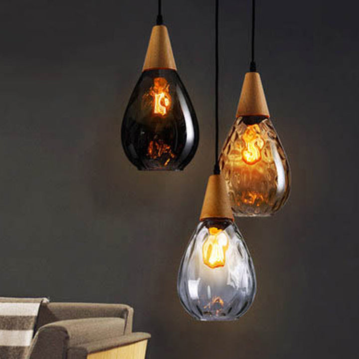Sleek clear glass teardrop pendant light, modern home lighting fixture.