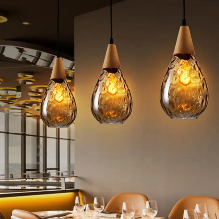 Modern teardrop glass pendant light, stylish ceiling lamp for homes.