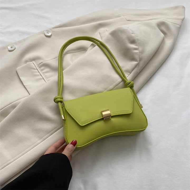 Chic green curved shoulder bag, ideal women's accessory for a stylish casual look.