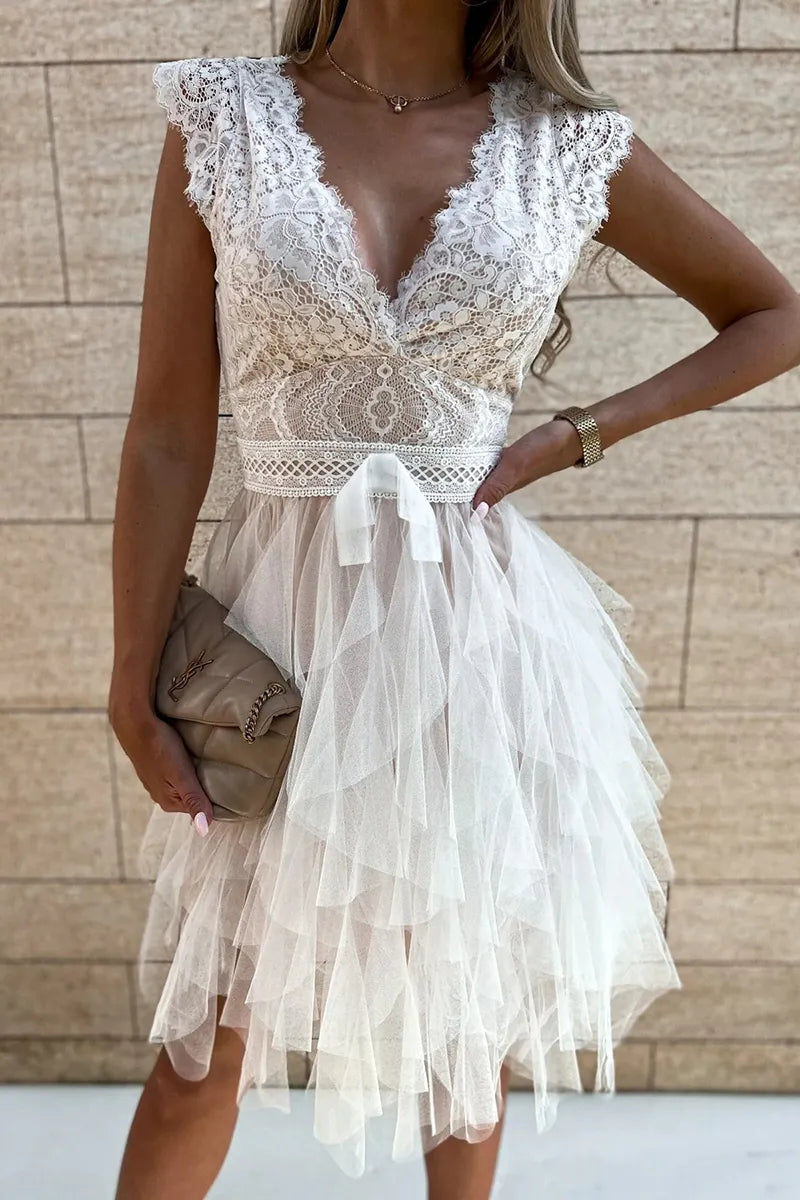 Women's elegant white mini party dress with ruffles, perfect for evening cocktails.