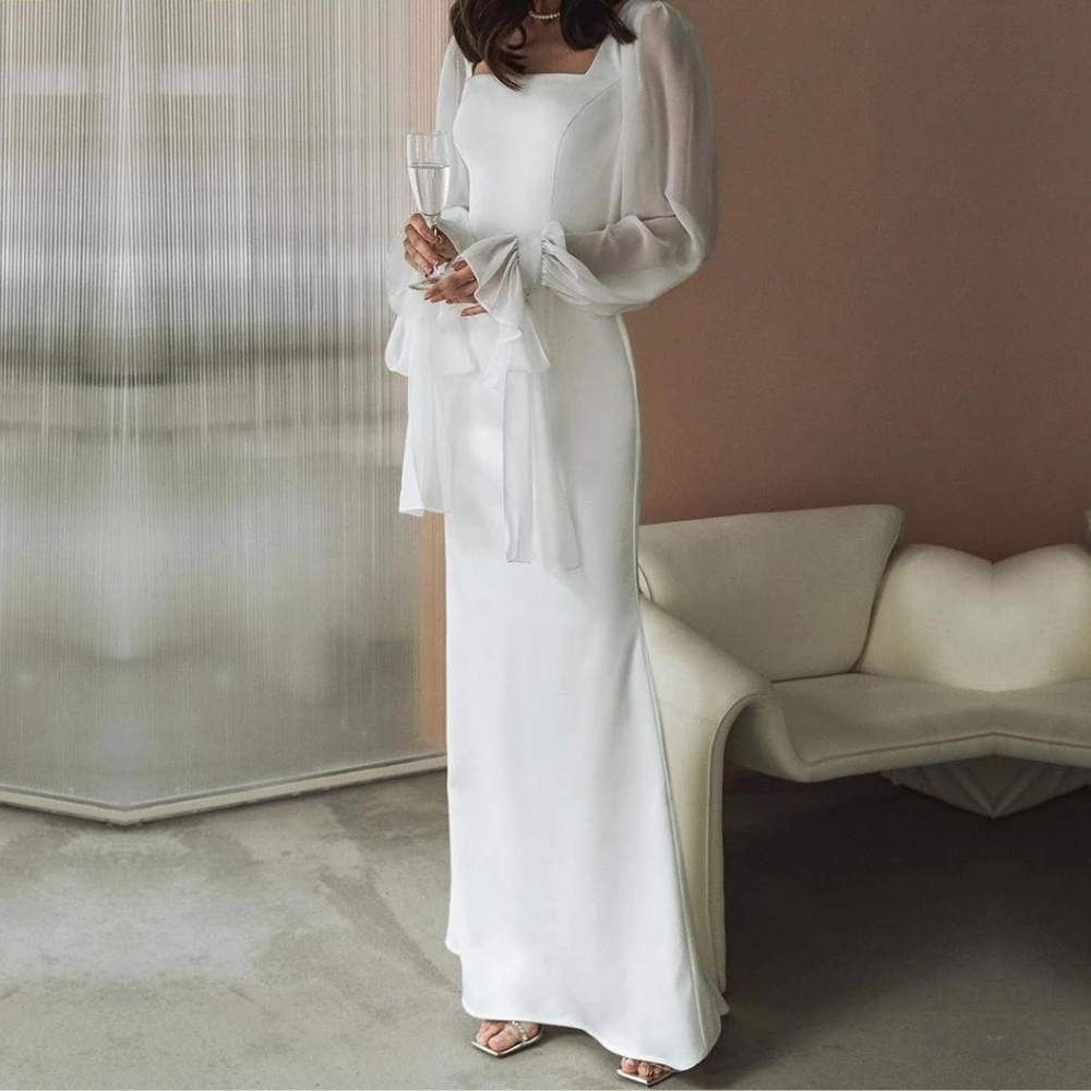 Woman wearing a sophisticated white square neck maxi dress, ideal for formal wear and special occasions.