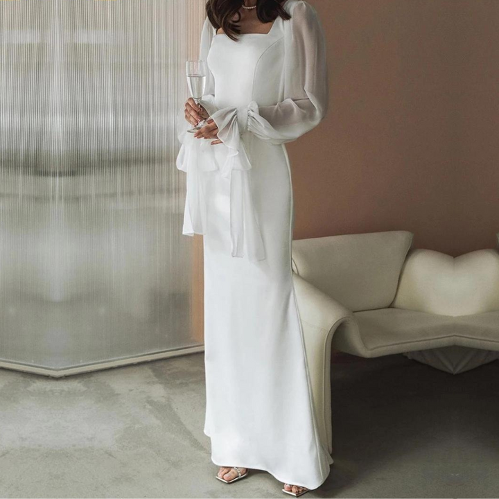 Woman wearing a sophisticated white square neck maxi dress, ideal for formal wear and special occasions.
