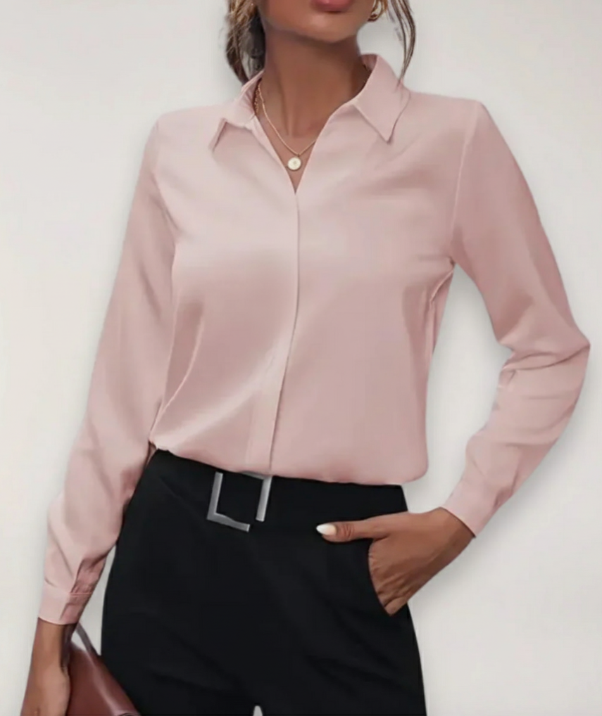 Close-up of a women's tailored button-up blouse, showcasing fabric detail and elegant design