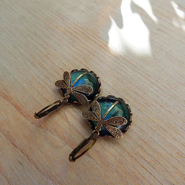 Model wearing women's antique crystal dragonfly earrings, showcasing elegant style and design.
