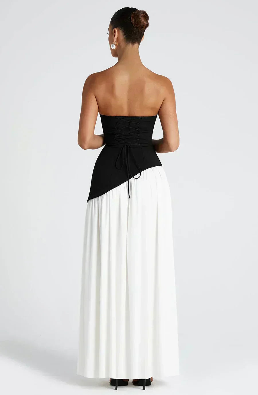 Modern wedding guest attire: women's elegant asymmetric maxi dress with a unique design, full-body shot.
