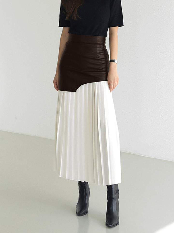 Detailed view of the fabric and pleating on a women's asymmetrical midi skirt, adding texture.