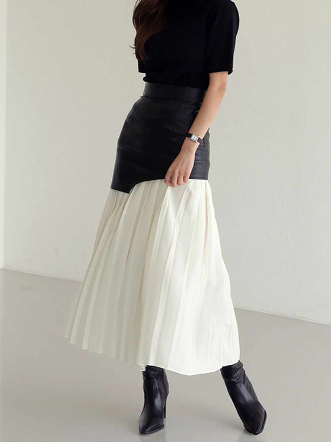 High-waisted asymmetrical pleated midi skirt for women, a versatile piece for casual or workwear.
