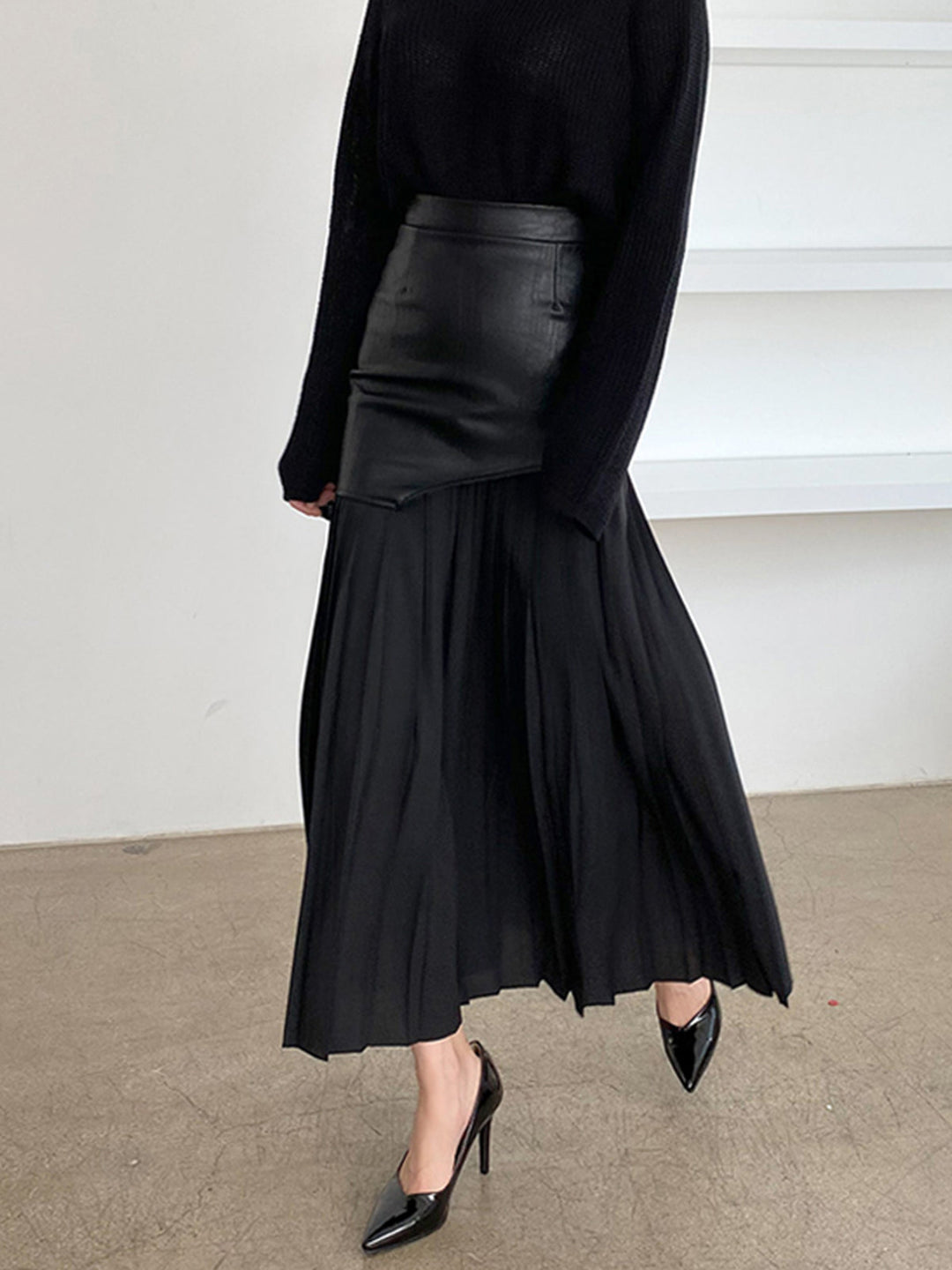 Women wearing a fashionable asymmetrical pleated midi skirt paired with a simple top for a casual look.