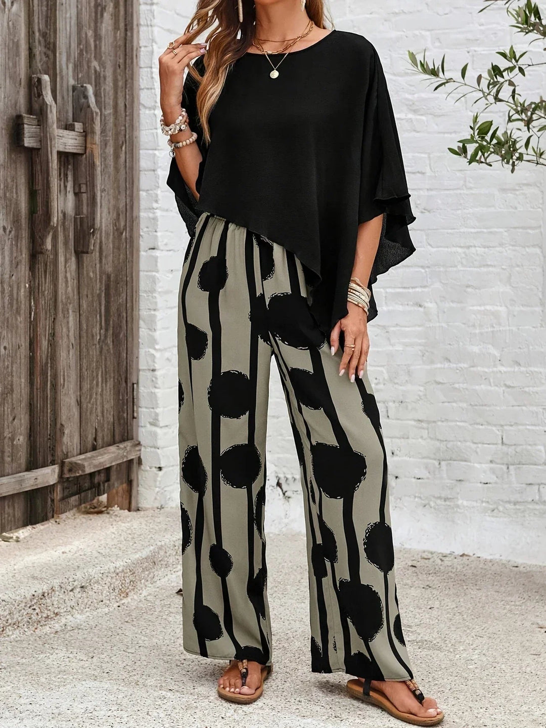 Modern women's co-ord set with a draped one-shoulder top and comfortable, flowing printed trousers