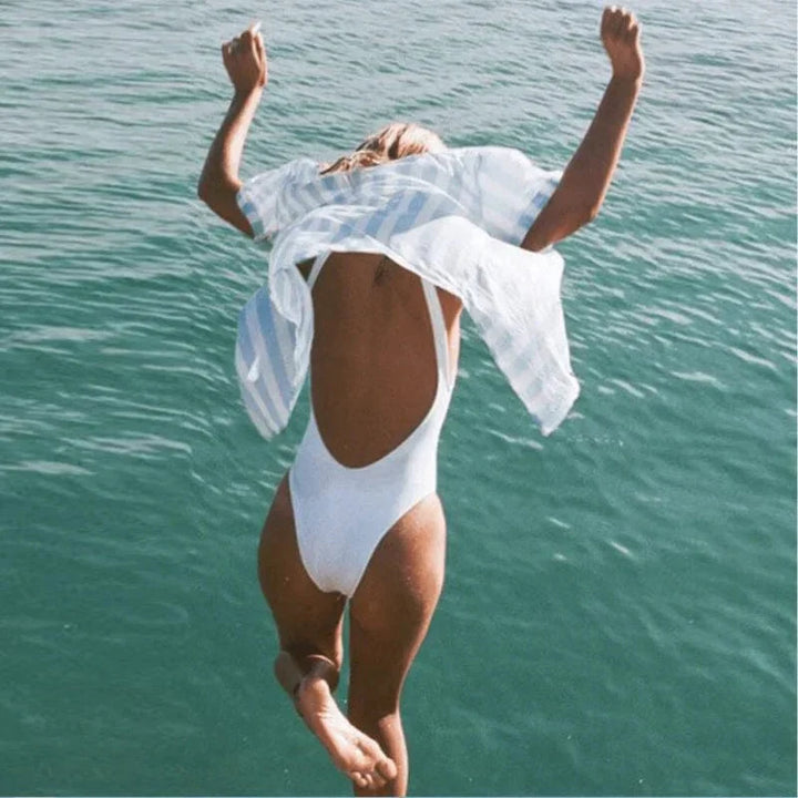 Women's elegant one-piece backless swimsuit. Classic style beachwear, perfect for your next vacation or pool day.