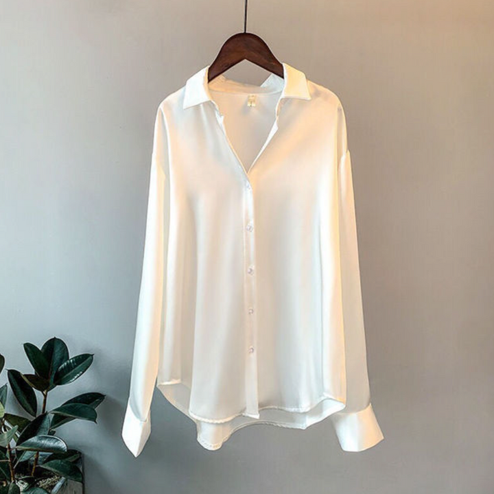 Stylish white button-down women's blouse, elegant and versatile office wear.