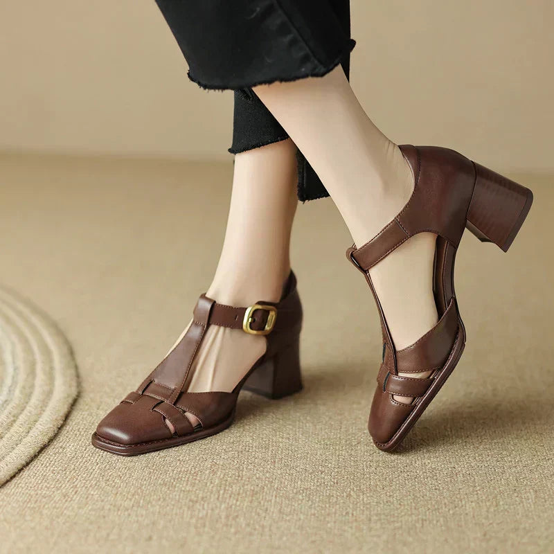 Pair of women's beige t-strap block heel sandals with a modern square toe, ideal for sophisticated summer outfits.