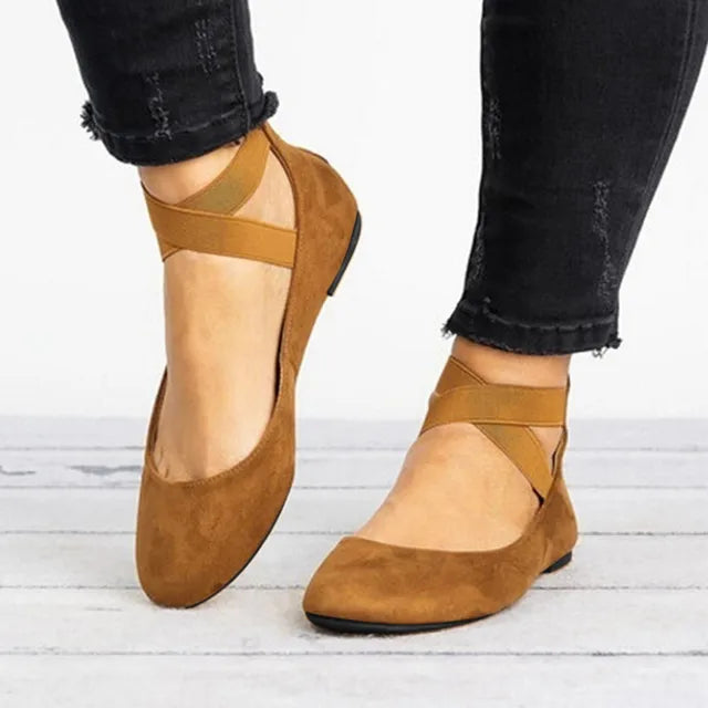 Women's ballet shoes in a soft pastel shade with elegant cross-straps, ideal for spring.