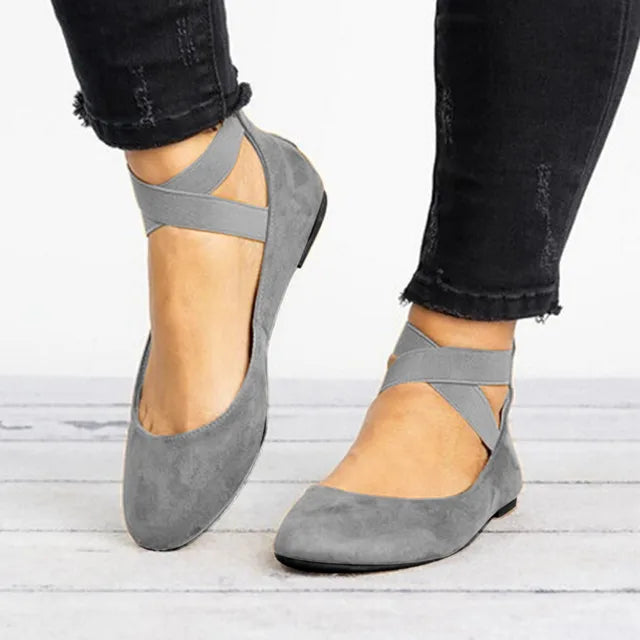 Versatile women's flats with unique cross-strap detail, offering comfort for everyday spring wear.
