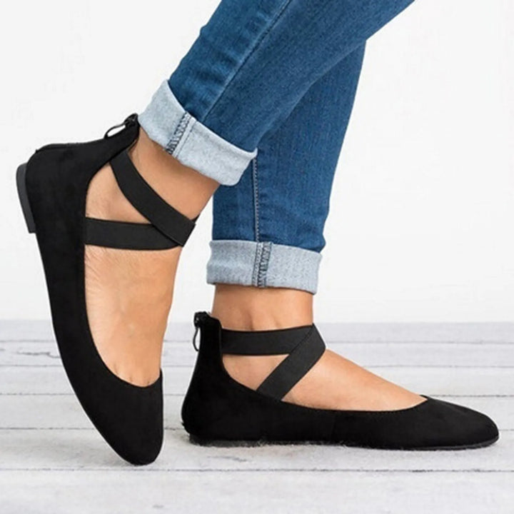 Close-up of elegant women's cross-strap ballet flats, showcasing quality craftsmanship and comfort.