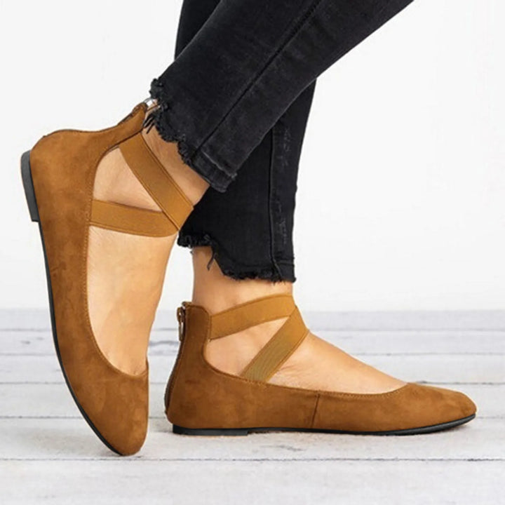 Stylish women's spring footwear: tan cross-strap ballet flats for a casual yet elegant look.