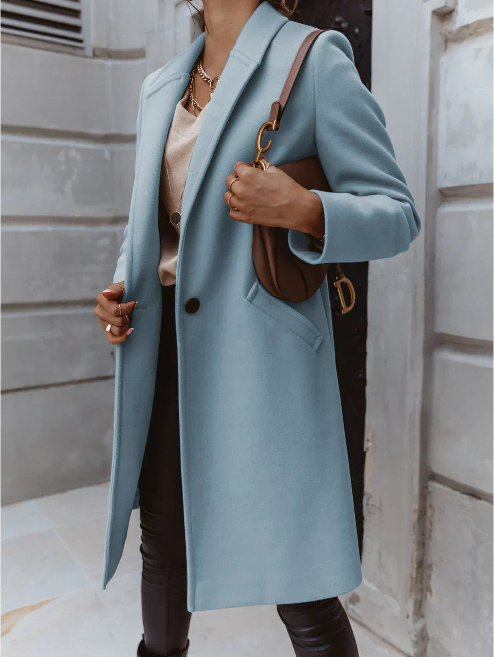 Classic women's button-front coat for formal events, a timeless piece of elegant outerwear.