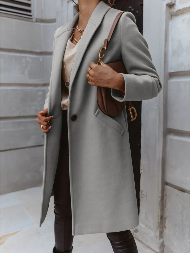 High-quality women's tailored coat, buttoned front, suitable for business and cold weather.