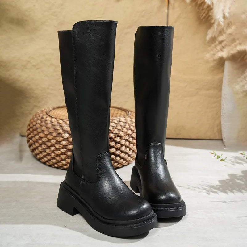 Elegant women's black leather knee-high boots with a high block heel, suitable for fall fashion