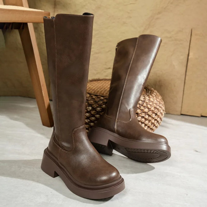 Fashionable women's leather knee-high boots with a high block heel, ideal for fall and winter