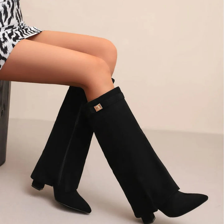 Fashionable women's long leather boots featuring a stylish buckle detail on the outer shaft.