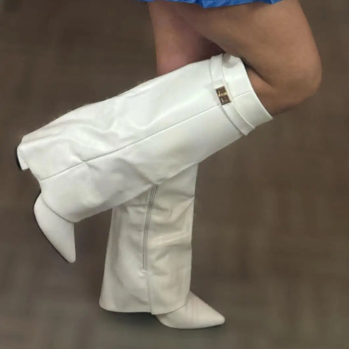 Close-up of the buckle accent on luxurious women's leather thigh-high boots, highlighting quality.