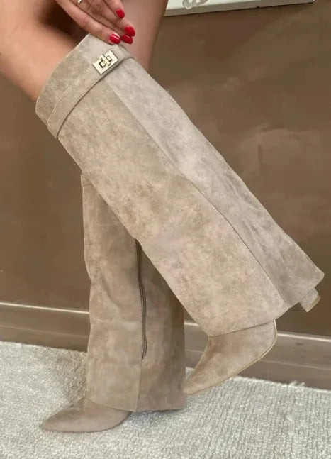 Full shot of women's leather thigh-high boots with buckle, showcasing their sleek design and winter style.