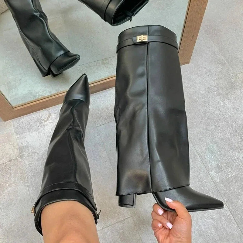 Studio shot of women's fashion leather thigh-high boots with prominent buckle, ideal for winter.