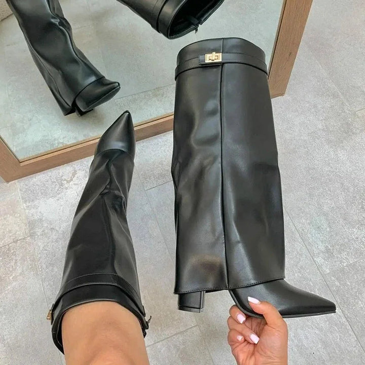 Studio shot of women's fashion leather thigh-high boots with prominent buckle, ideal for winter.