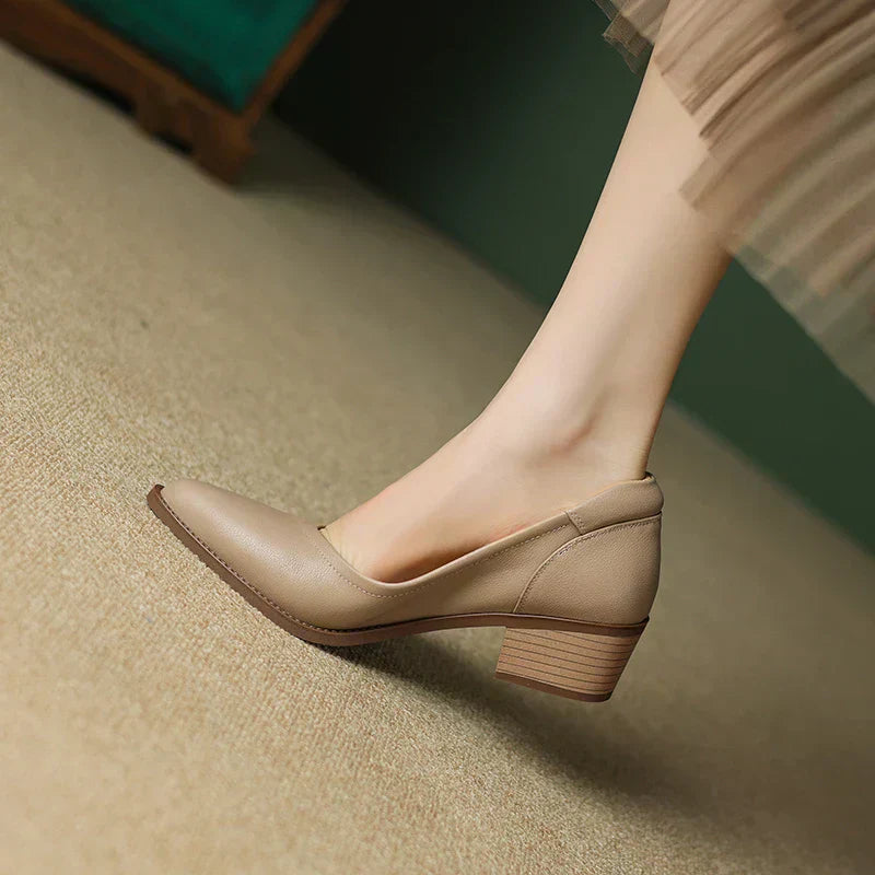 Classic women's slip-on pumps, pointed toe mid-heel design, perfect for work or elegant occasions.