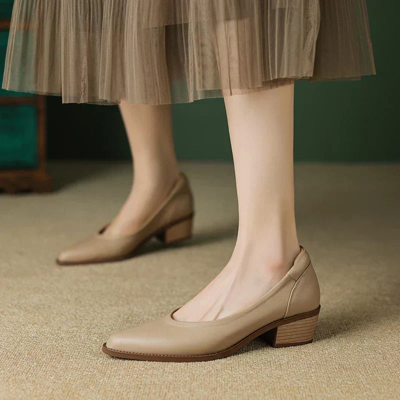 Versatile black mid-heel pumps for women, featuring a chic pointed toe and stable block heel.